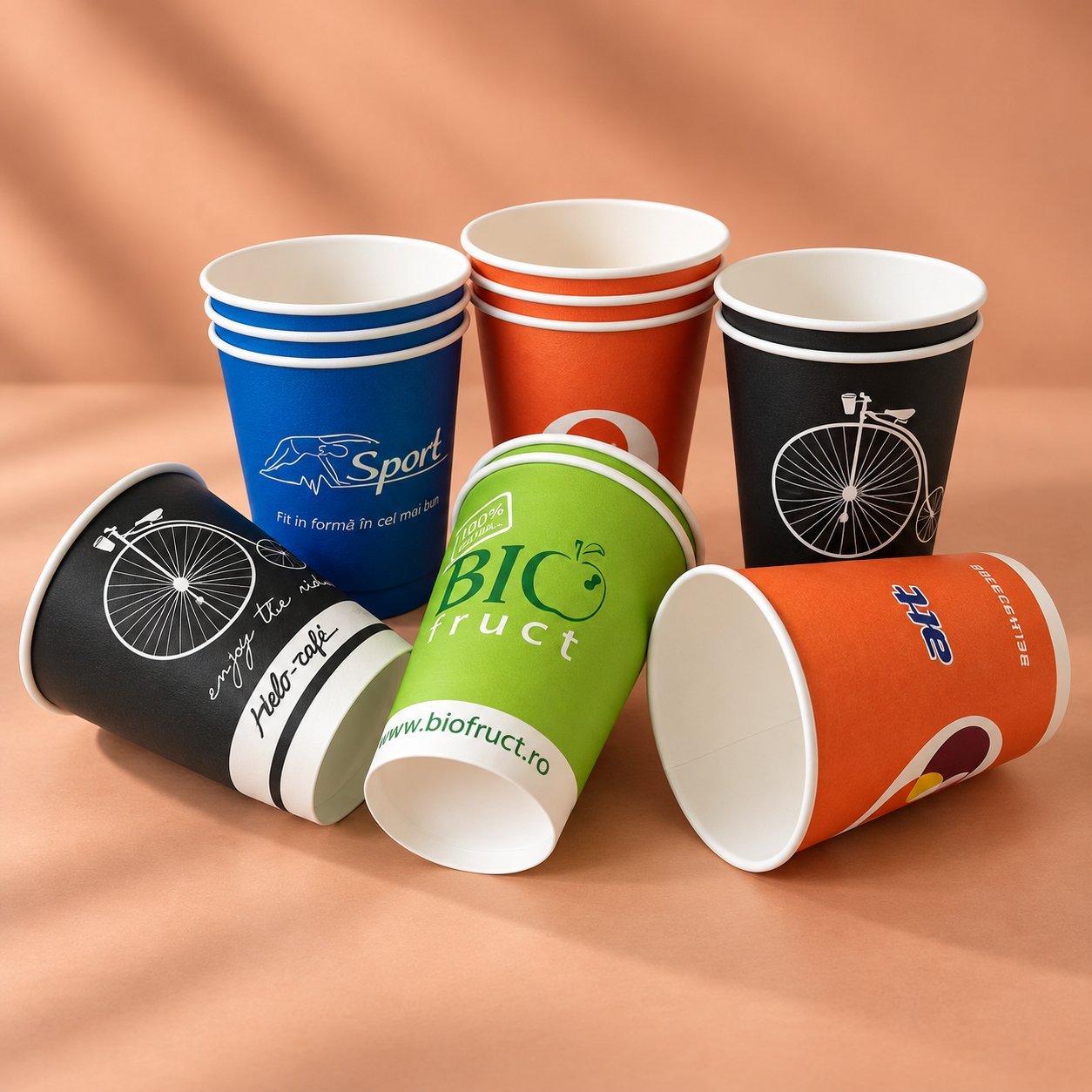 Branded paper cups with detailed logo prints showing different printing methods.