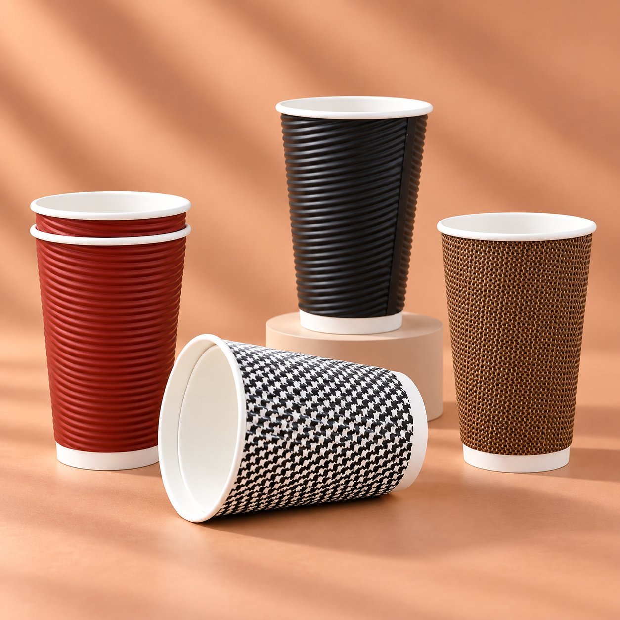 Textured and specialty-finished paper cups including red ribbed, houndstooth, and dotted kraft.