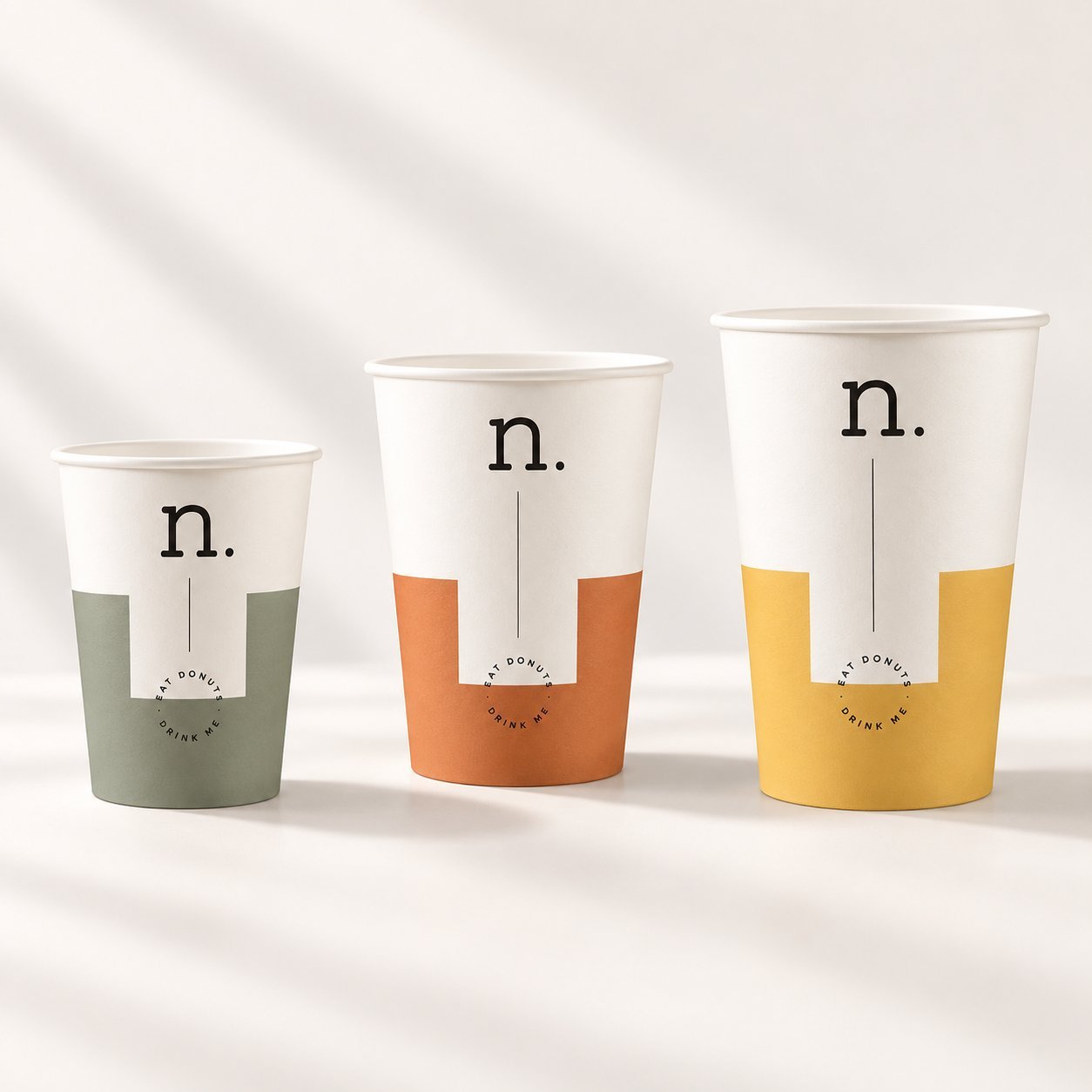 Three paper cups in small, medium and large sizes with the same logo on each, illustrating SKU fragmentation across sizes.