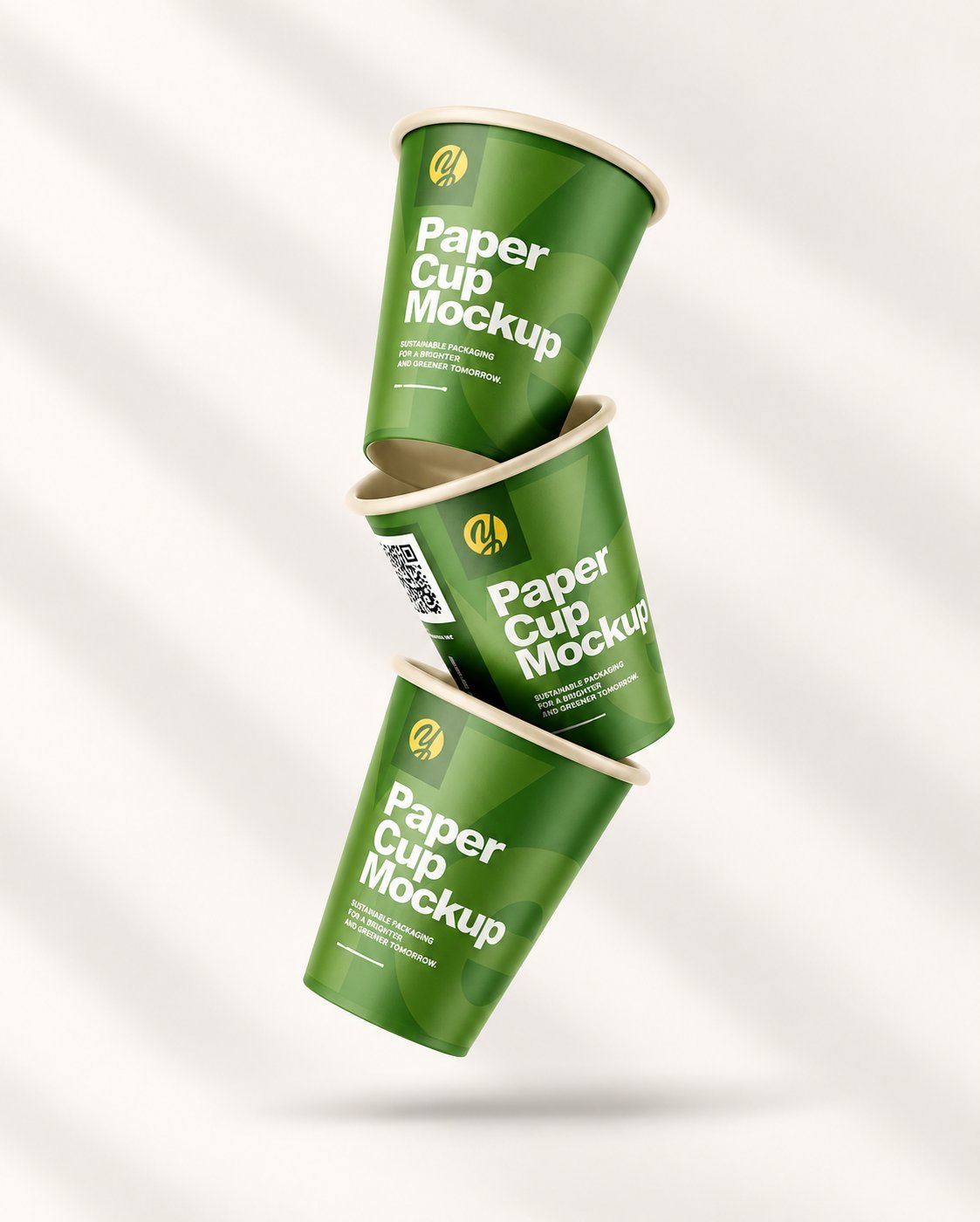 Three branded green paper cups stacked together, showing the kind of finished output a buyer receives from production.