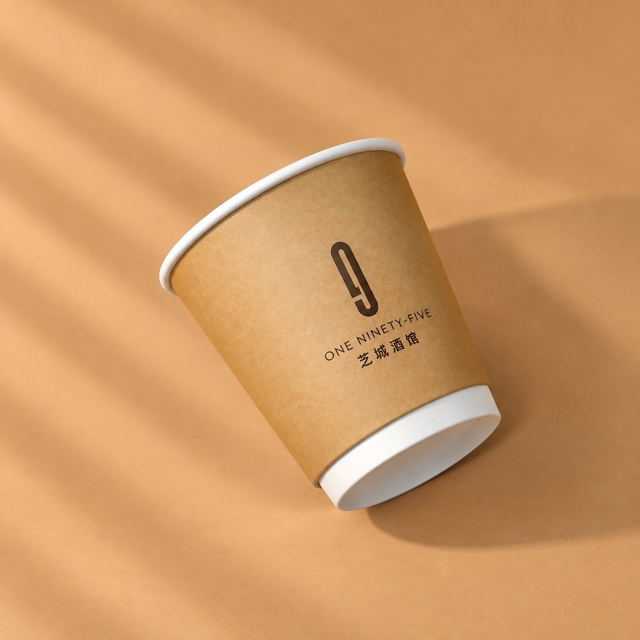 Kraft paper cup in ONE NINETY-FIVE branding, tilted on its side, showing double-wall construction's smooth surface and heavier wall presence.