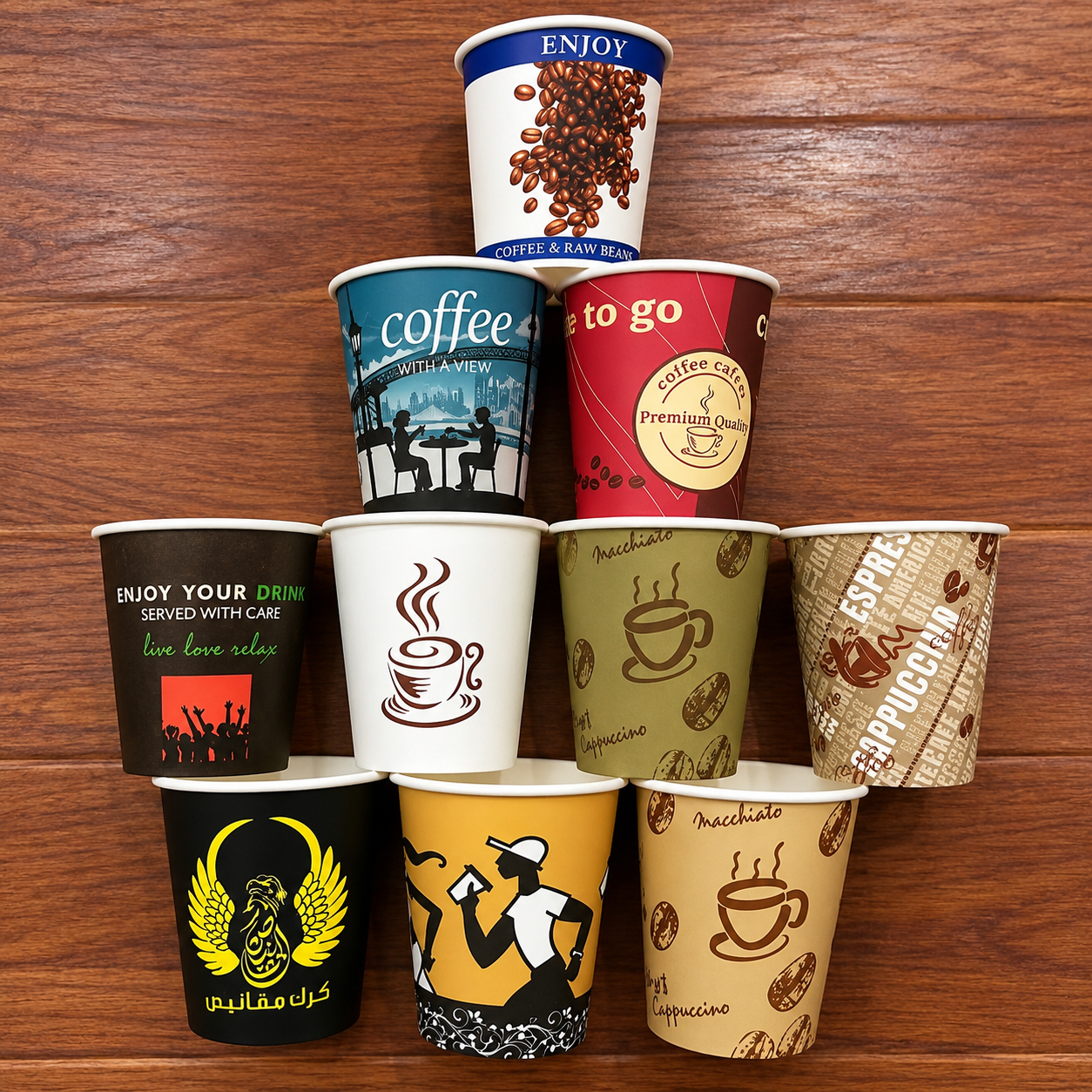Coffee themed printed paper cups stacked against a wooden background