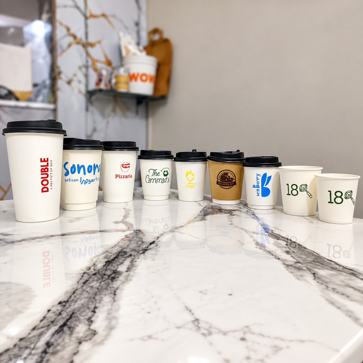 Custom printed paper cups in multiple sizes with lids for finished SKU configuration review