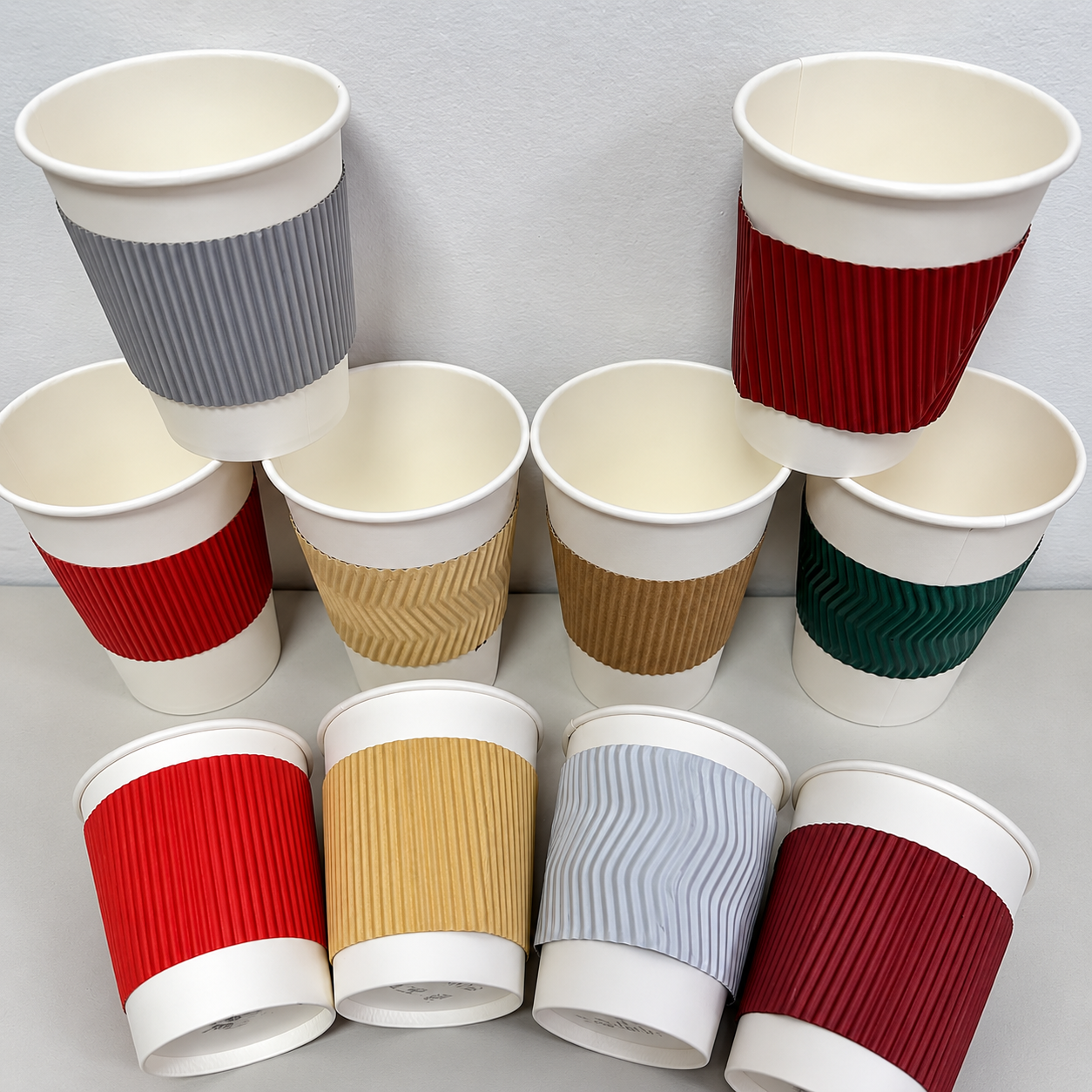 Assorted paper cups with colored ripple sleeves for comparing cup construction and exterior components