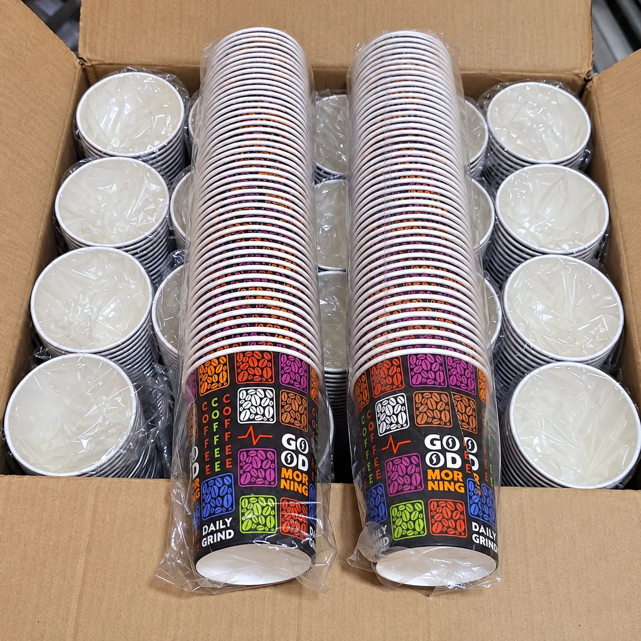 Printed paper cups packed in a carton with plastic wrapping