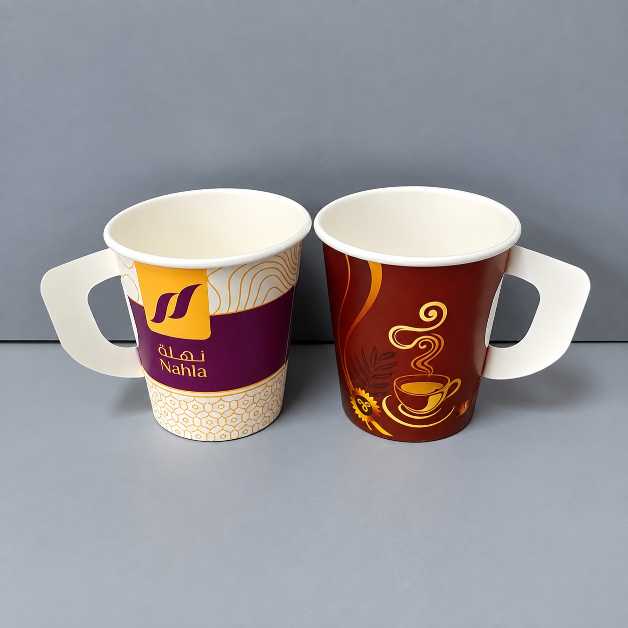 Two printed paper cups with handles showing different cup construction details