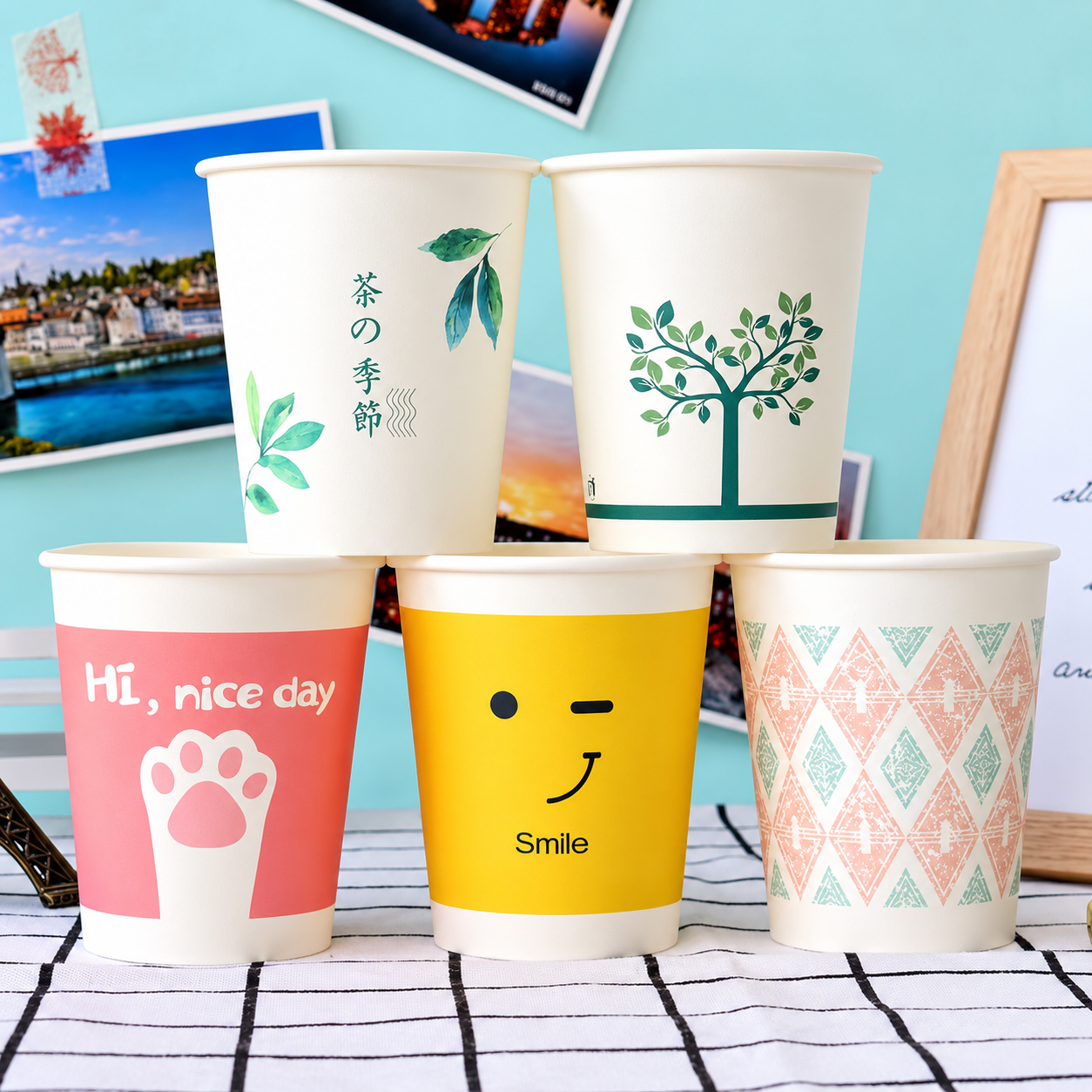 Pastel custom paper cups with simple printed artwork and logo-style designs
