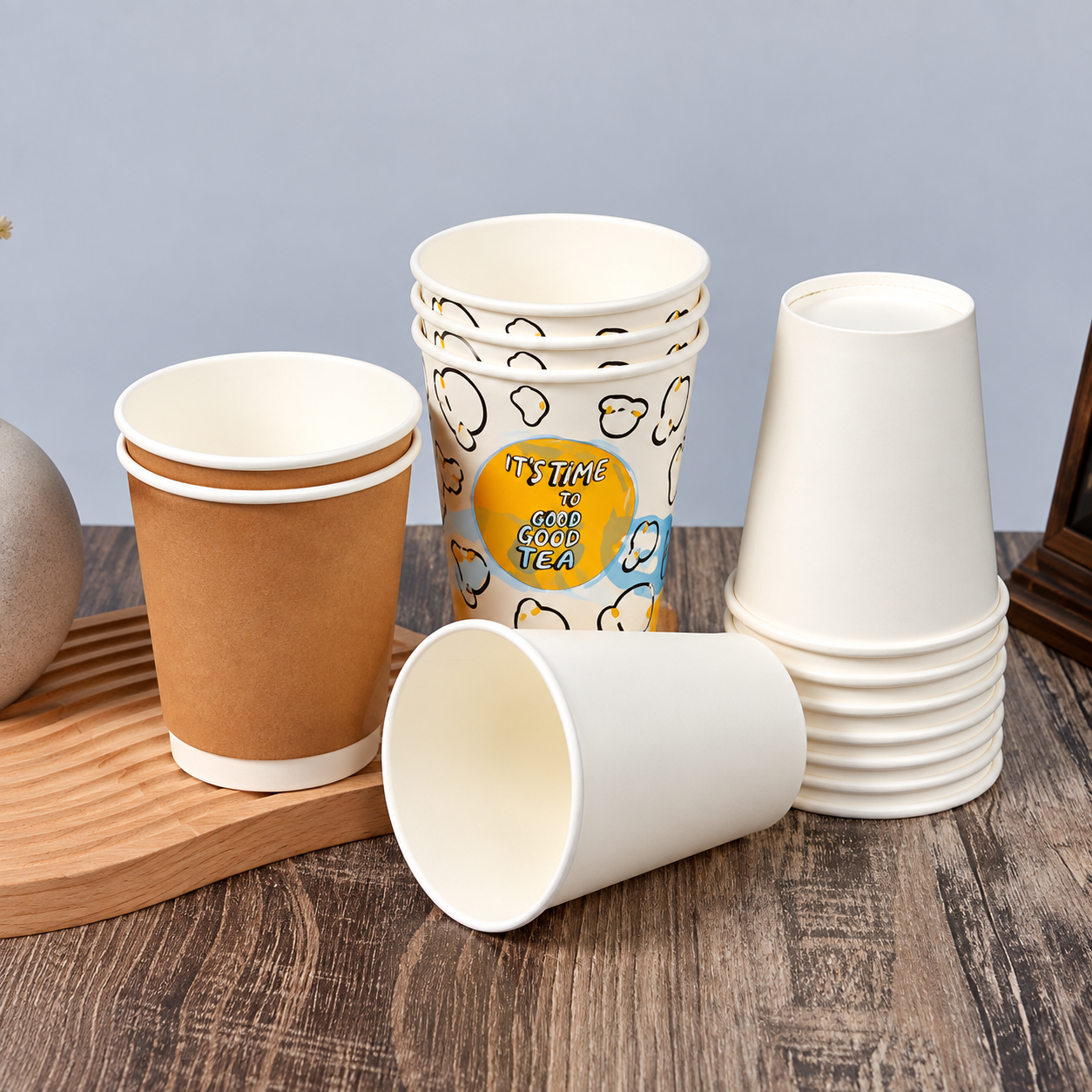Plain and printed paper cups arranged to compare batch consistency and cup construction