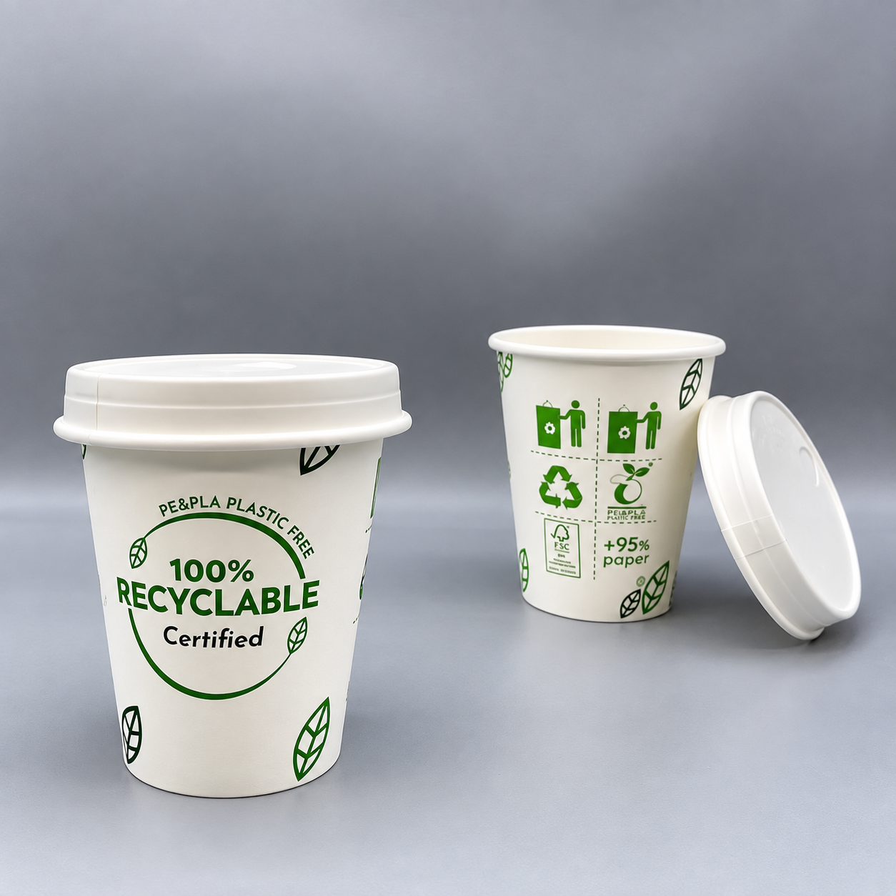 Paper cups showing recyclable and plastic free environmental claim icons